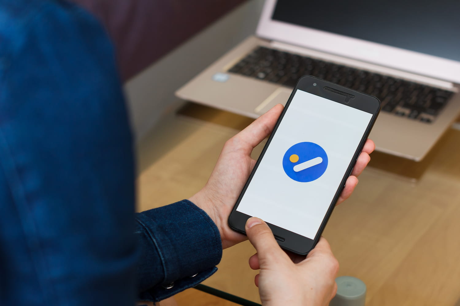 Close up to female hands holding smartphone opening up the Google Tasks application for team management tools.