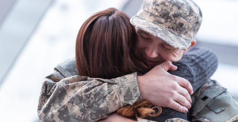 military couple embrace