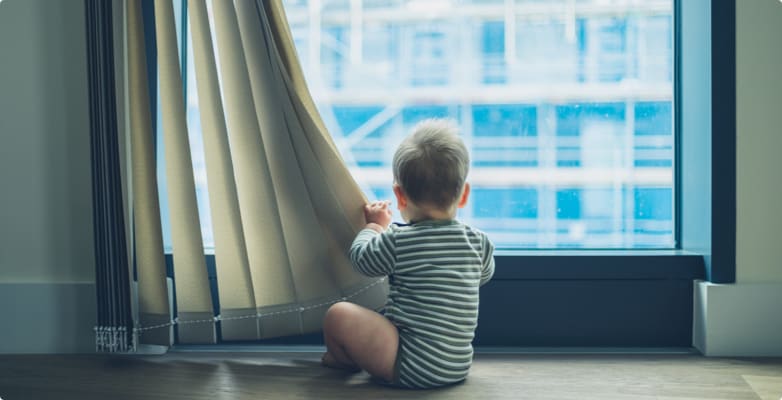 baby near curtains