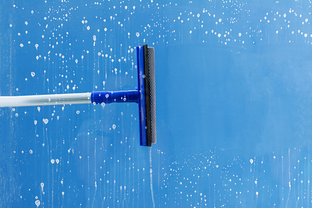 a squeegee cleaning glass