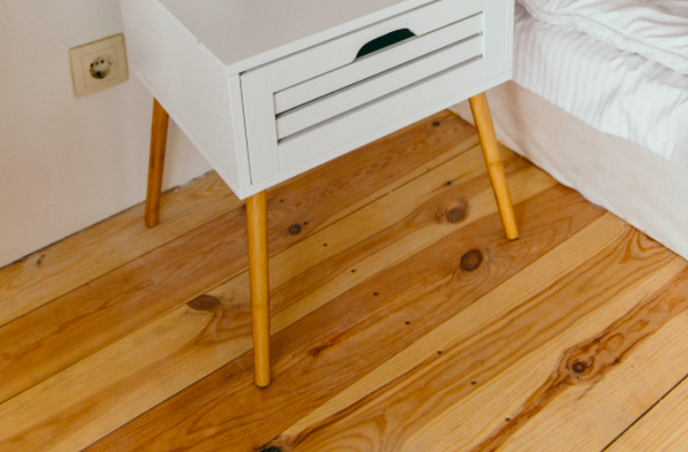 wooden floor in bedroom next to bed and night stand