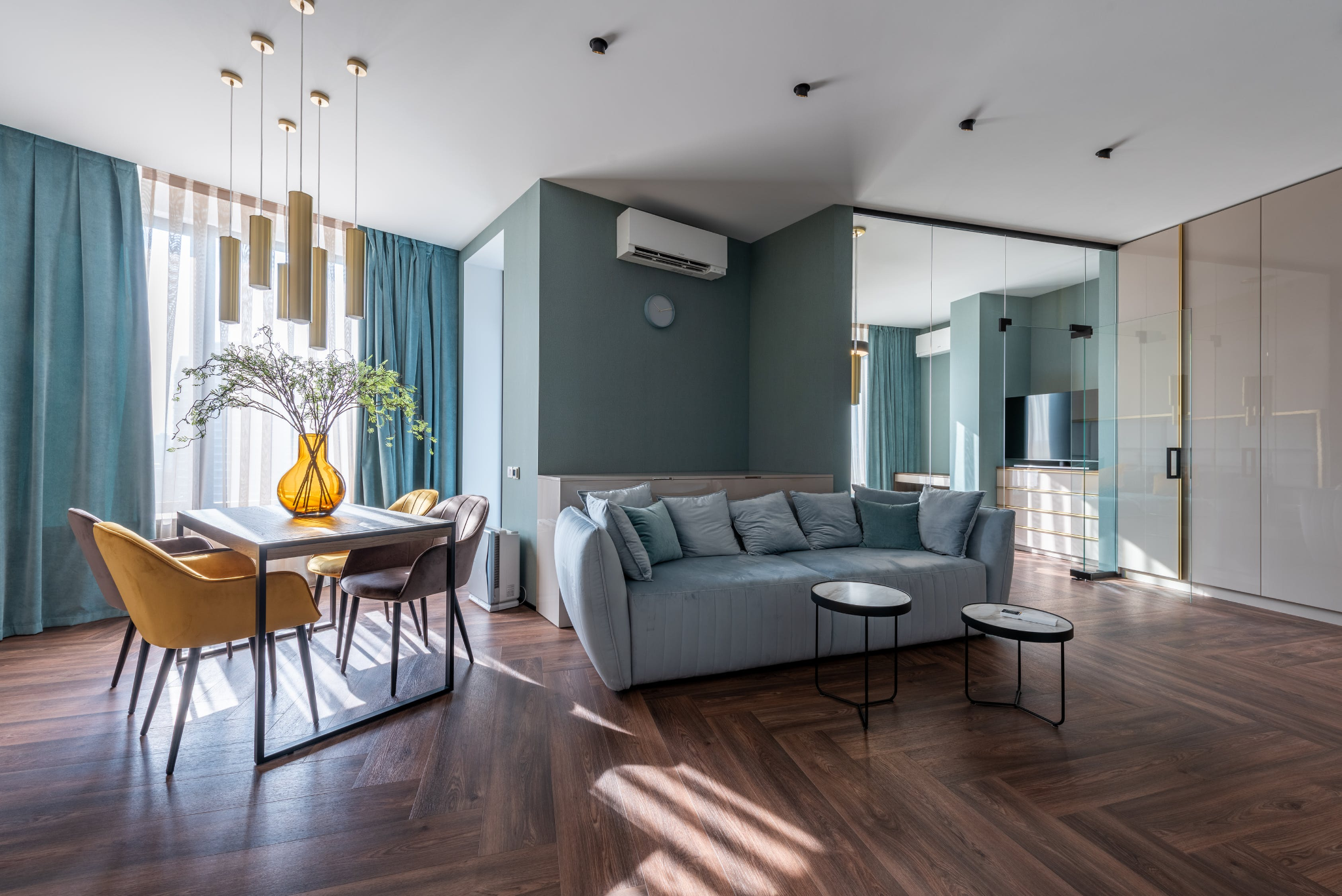 Predominantly light blue living room with dark brown parquet flooring