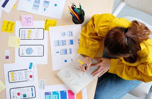 A young woman works on herUser Interface (UI) and User Experience (UX) Design Diploma at ABM College