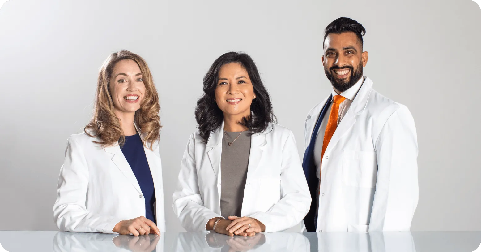 an image of 3 people standing in doctor uniforms