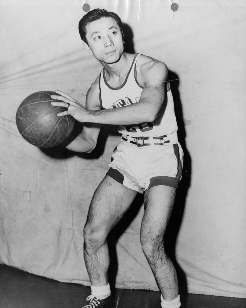 Wat Misika posing for a basketball photo in his earlier years