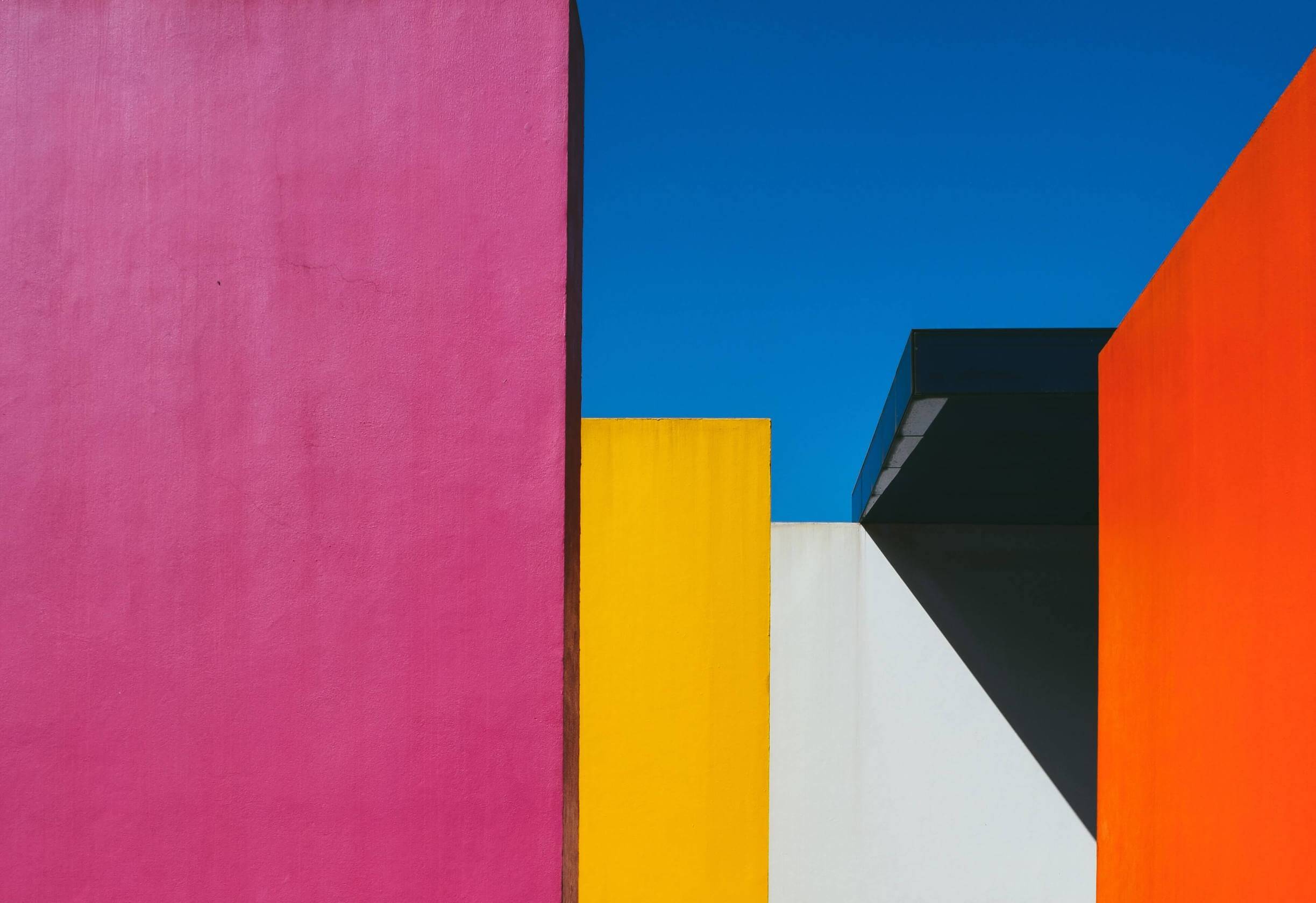 Colorful, modern buildings that evoke the art of Piet Mondrian set against a blue sky