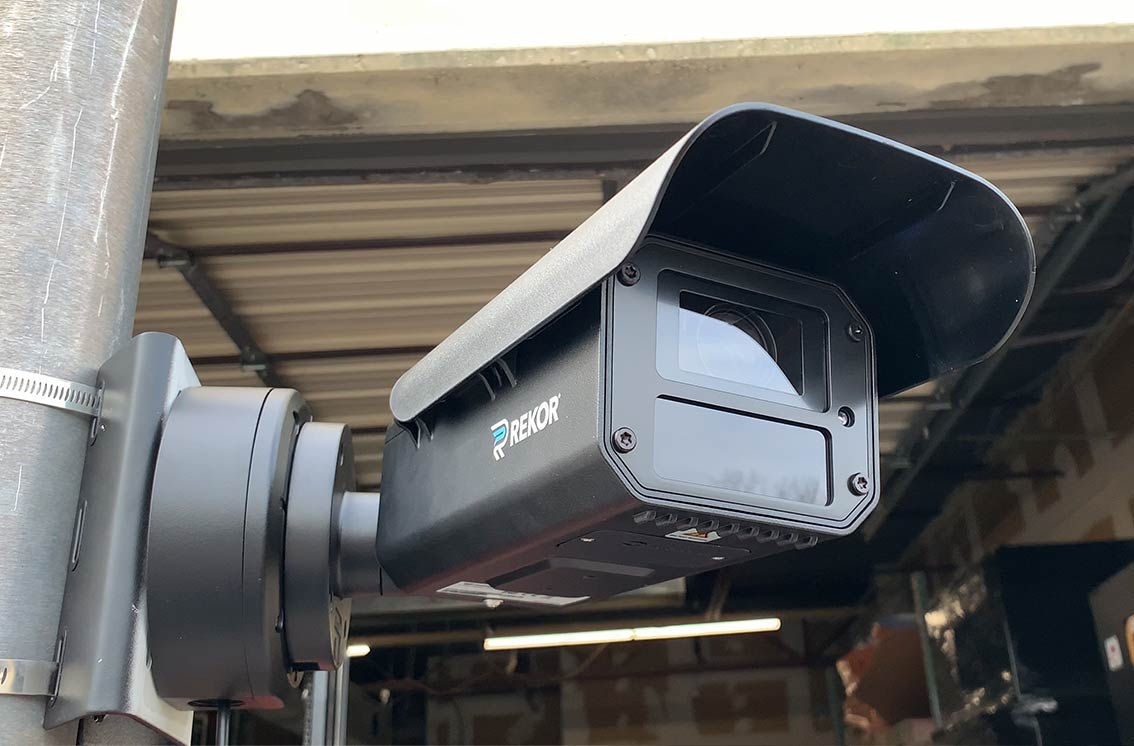 Rekor Edge Pro camera system up close mounted to a pole with garage in background