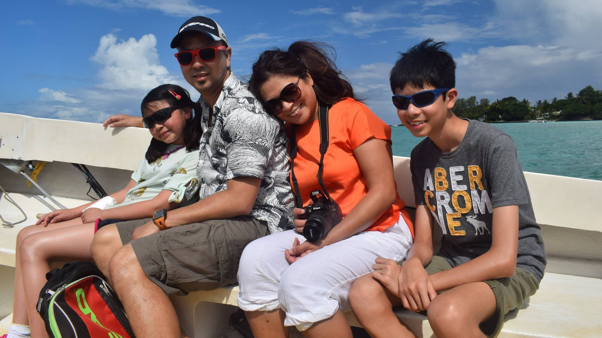 Engineer Sheila sits with her family on a boat.