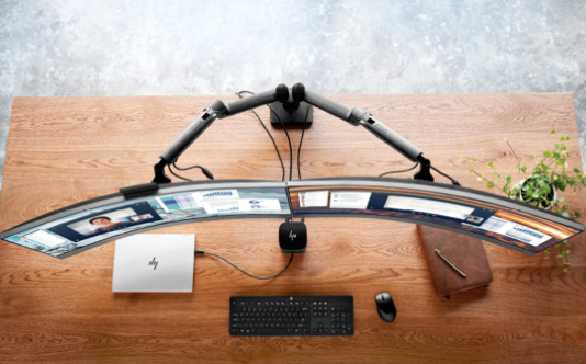 hp work station with a laptop and dual curved monitors