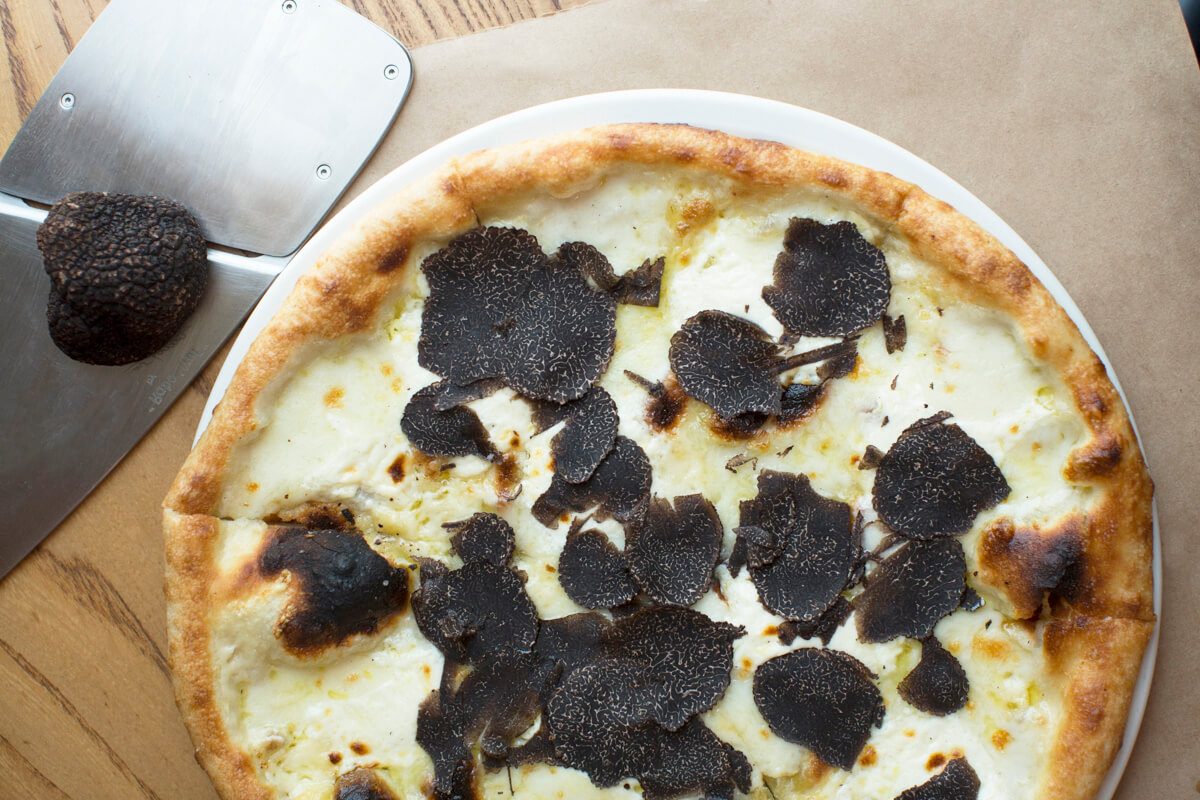 pizza covered in shaved black truffles