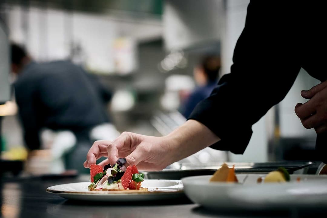 Koch dekoriert eine Speise