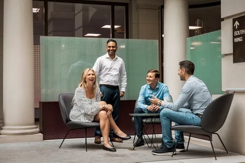 Photo of a group of people speaking to each other