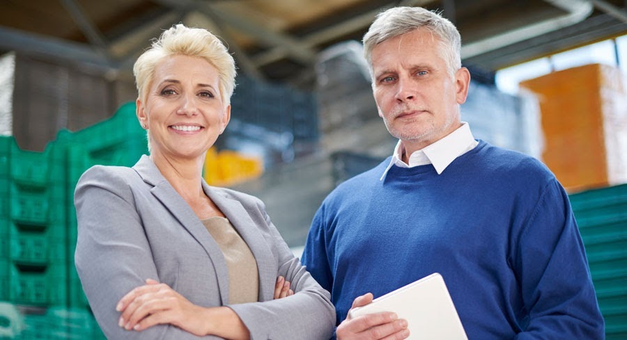 woman and man logistics managers in warehouse