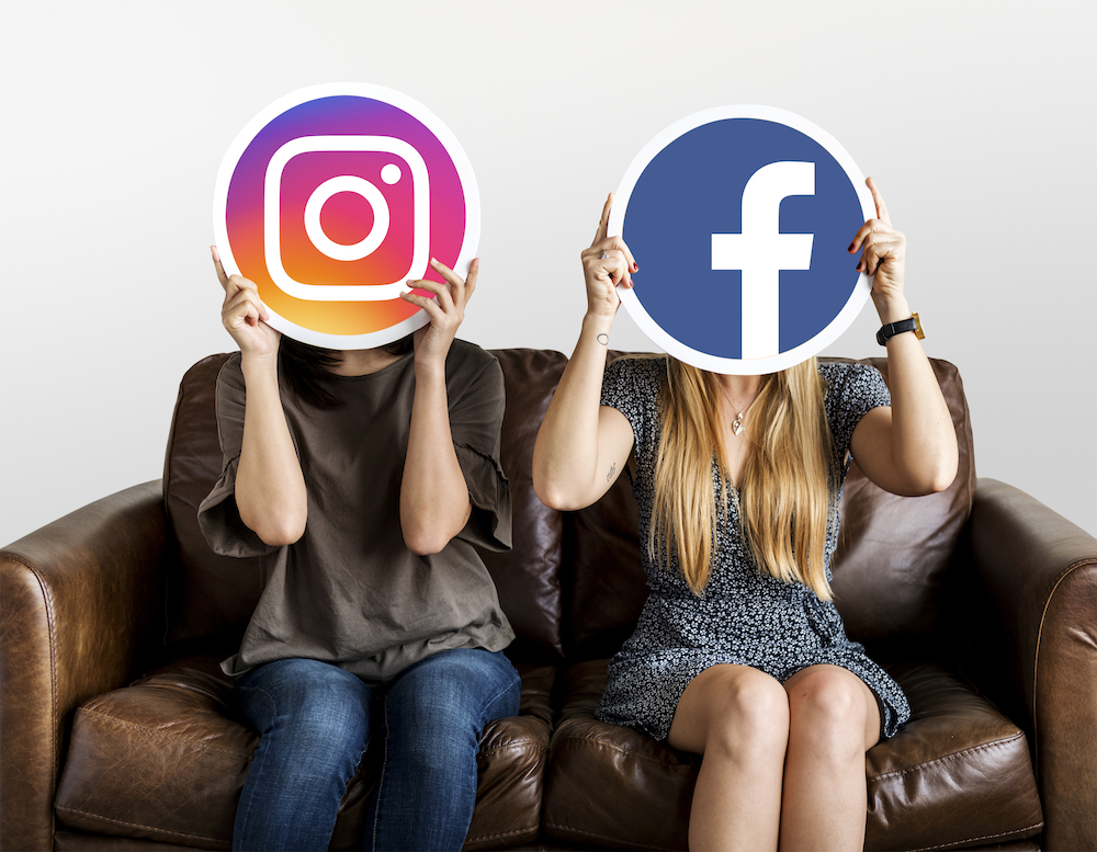 girls holding social media icons for online business