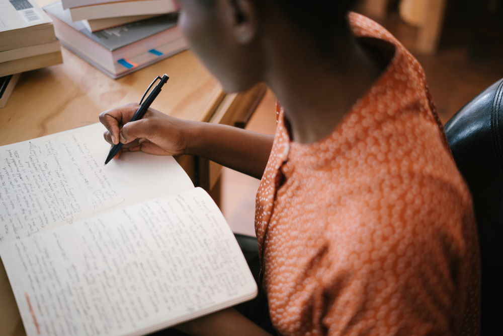 A woman studying the Bible and writing notes
