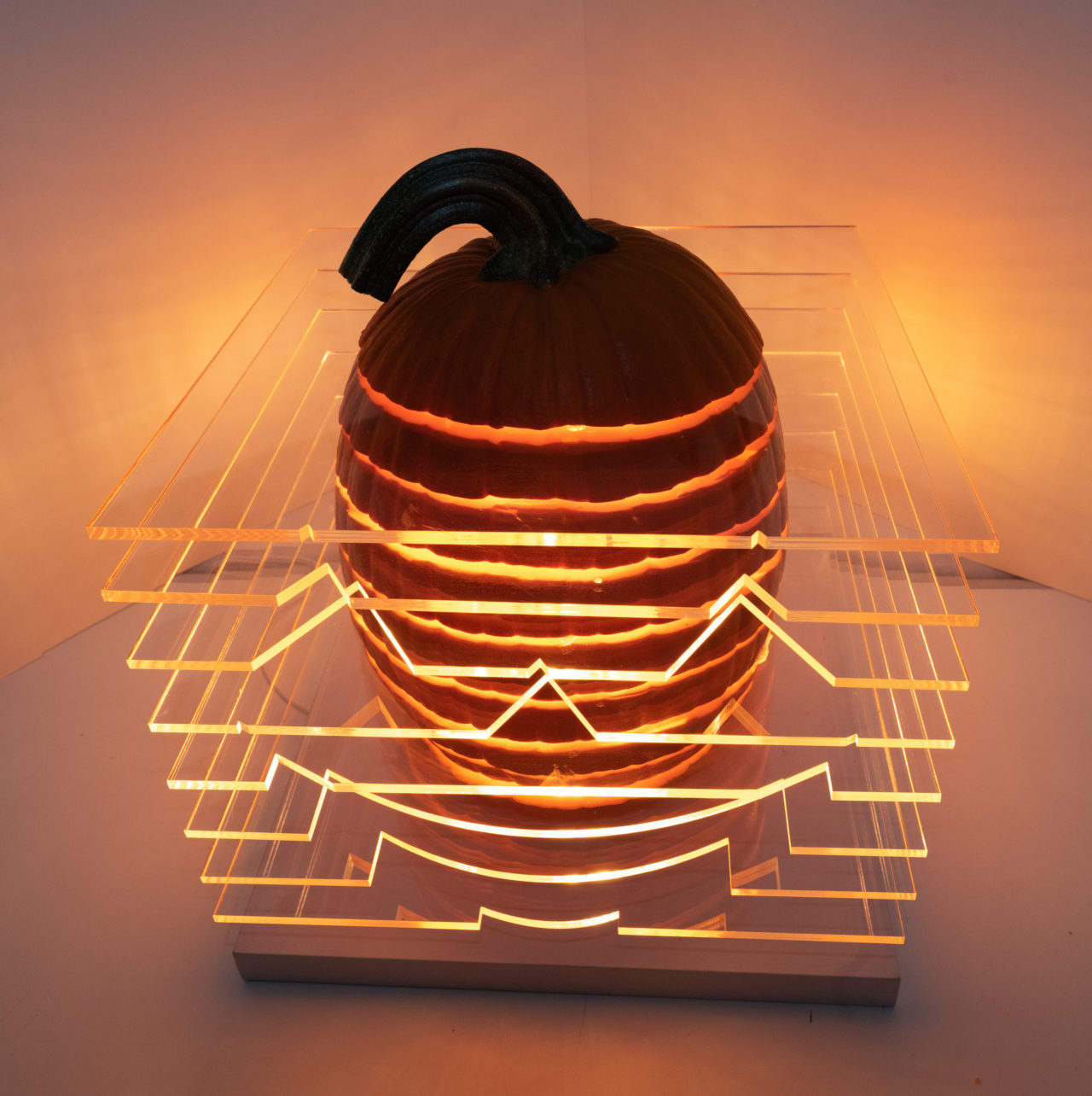 Pumpkin with multiple horizontal slixes with inserted plexi sheets and lit from within