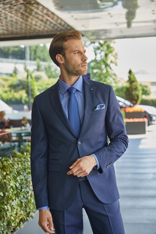 Fall Winter 2021-2022 Model in a Blue Suit by the Hotel Lobby