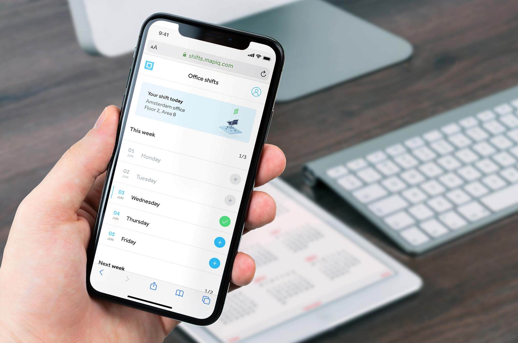 Person holding phone with Mapiq app open