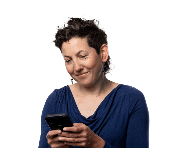 Woman smiling and looking at a cell phone