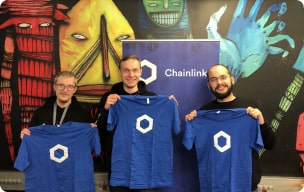 Chainlink community members holding Chainlink t-shirts