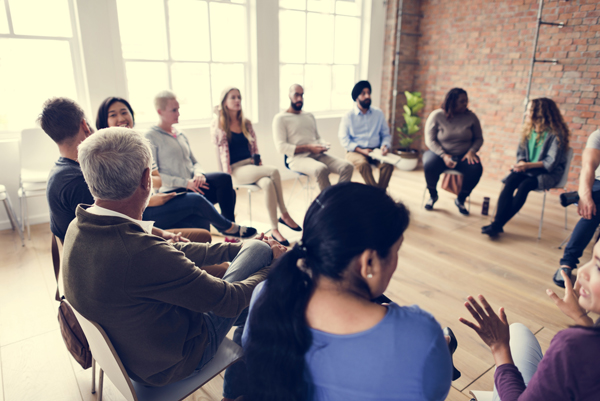 large group of adults sitting in a circle