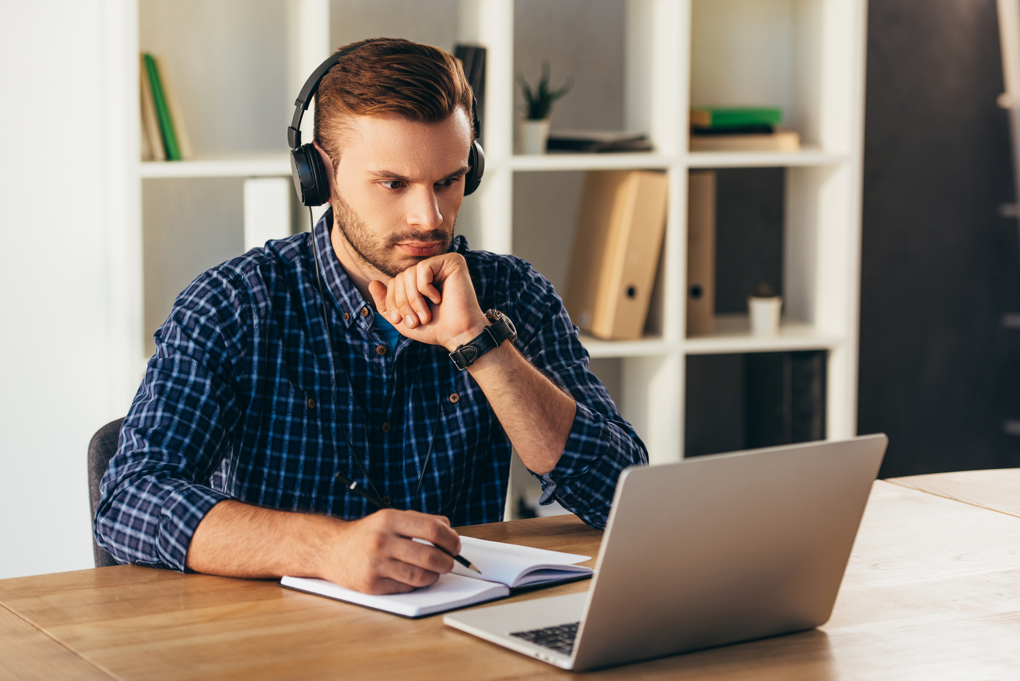 Man with headphones at a laptop