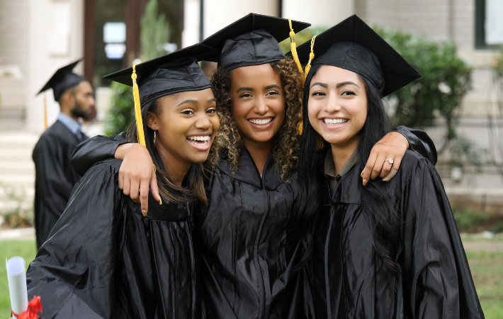 three female graduates pose for a photo