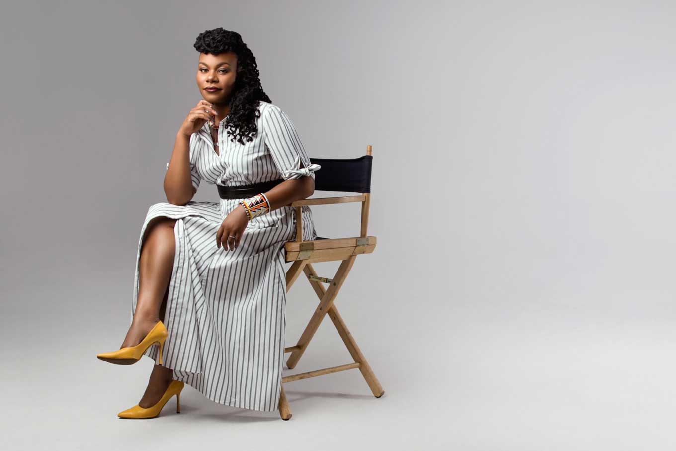 Gloria Watson sitting on a director's chair