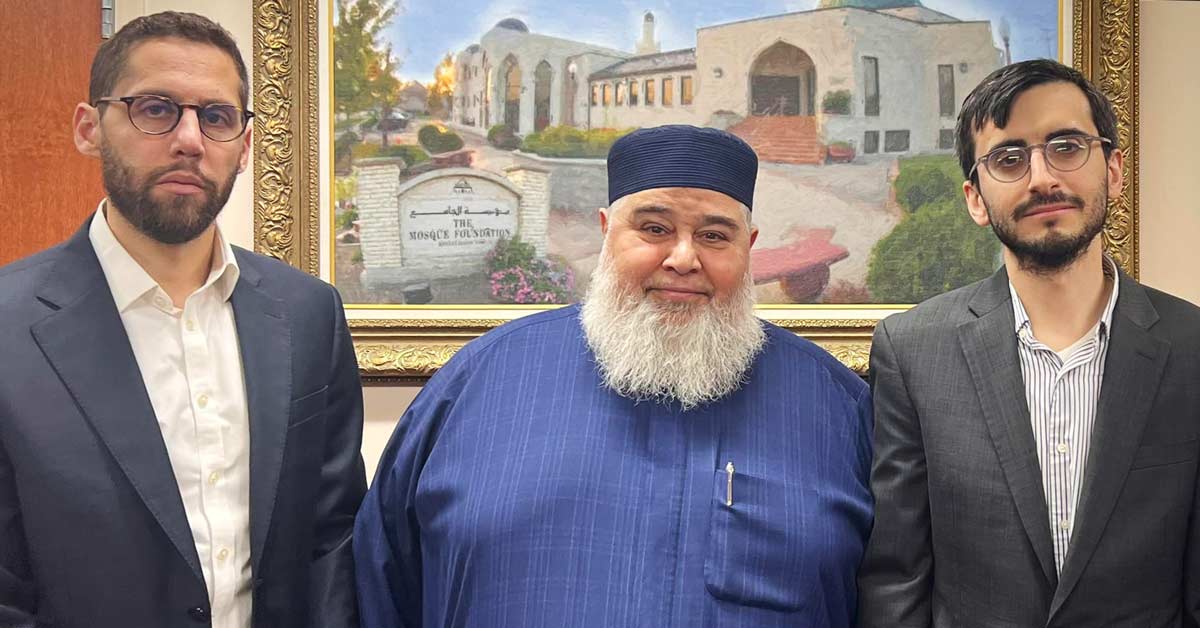 Two rabbis stand for a photo with the Imam of the mosque where the funeral was held