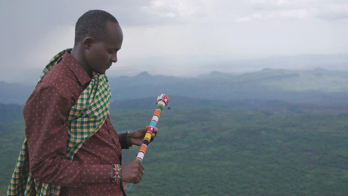 A still from "The Battle for Laikipia" where an Indigenous rancher looks out onto the land