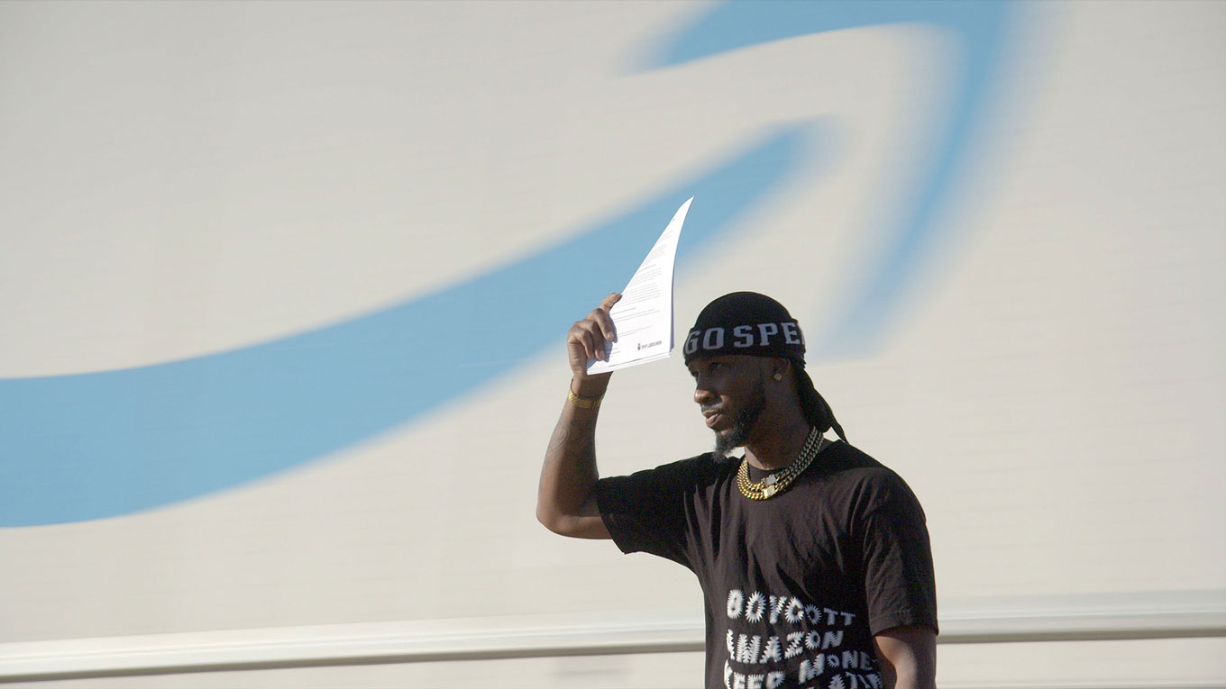 A still from "Union," in which Amazon union leader Matt Swails holds up a piece of paper to block the sun