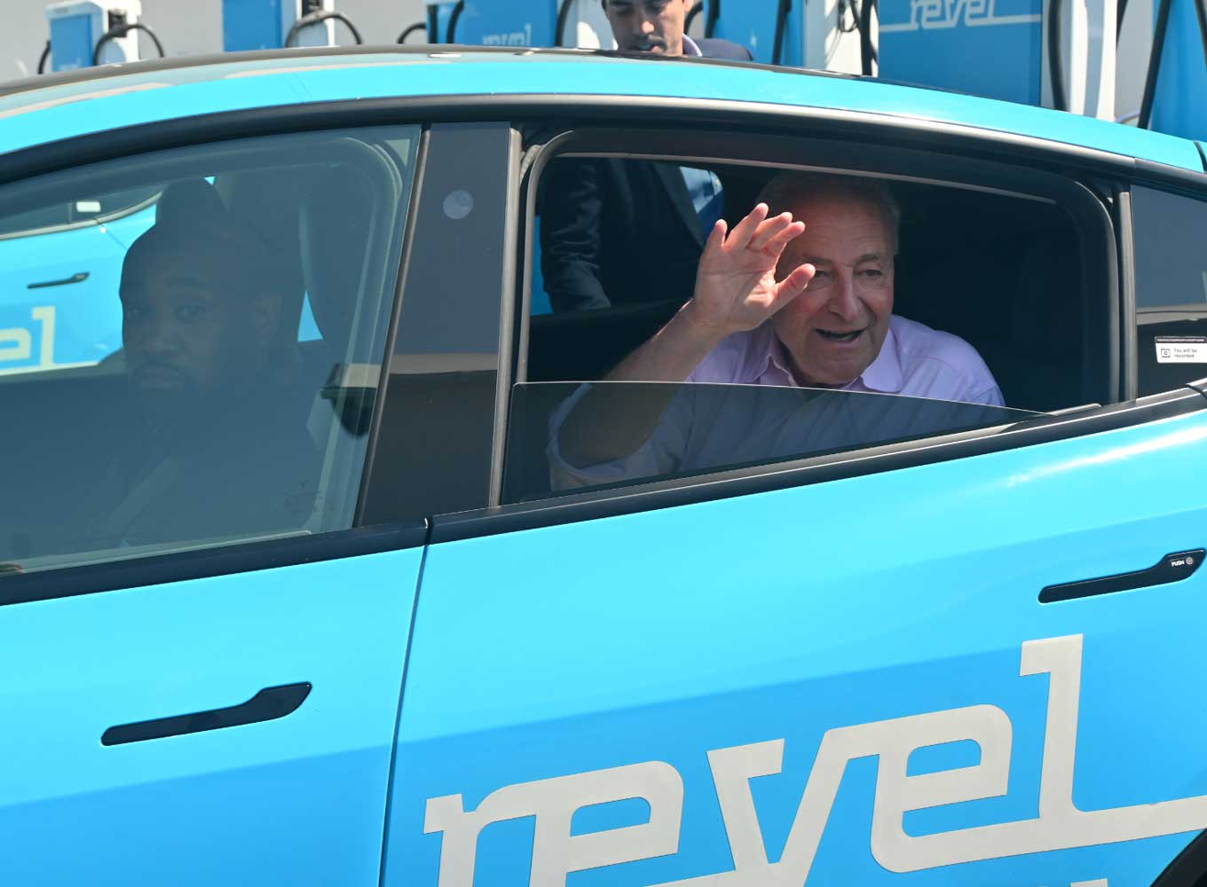 Chuck Schumer rides in the back seat of a Revel vehicle 