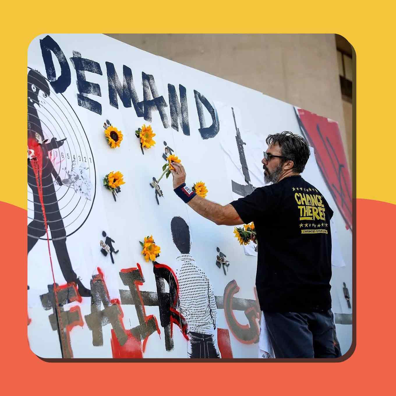 Manuel Oliver adds a flower to a mural honoring lives lost to gun violence