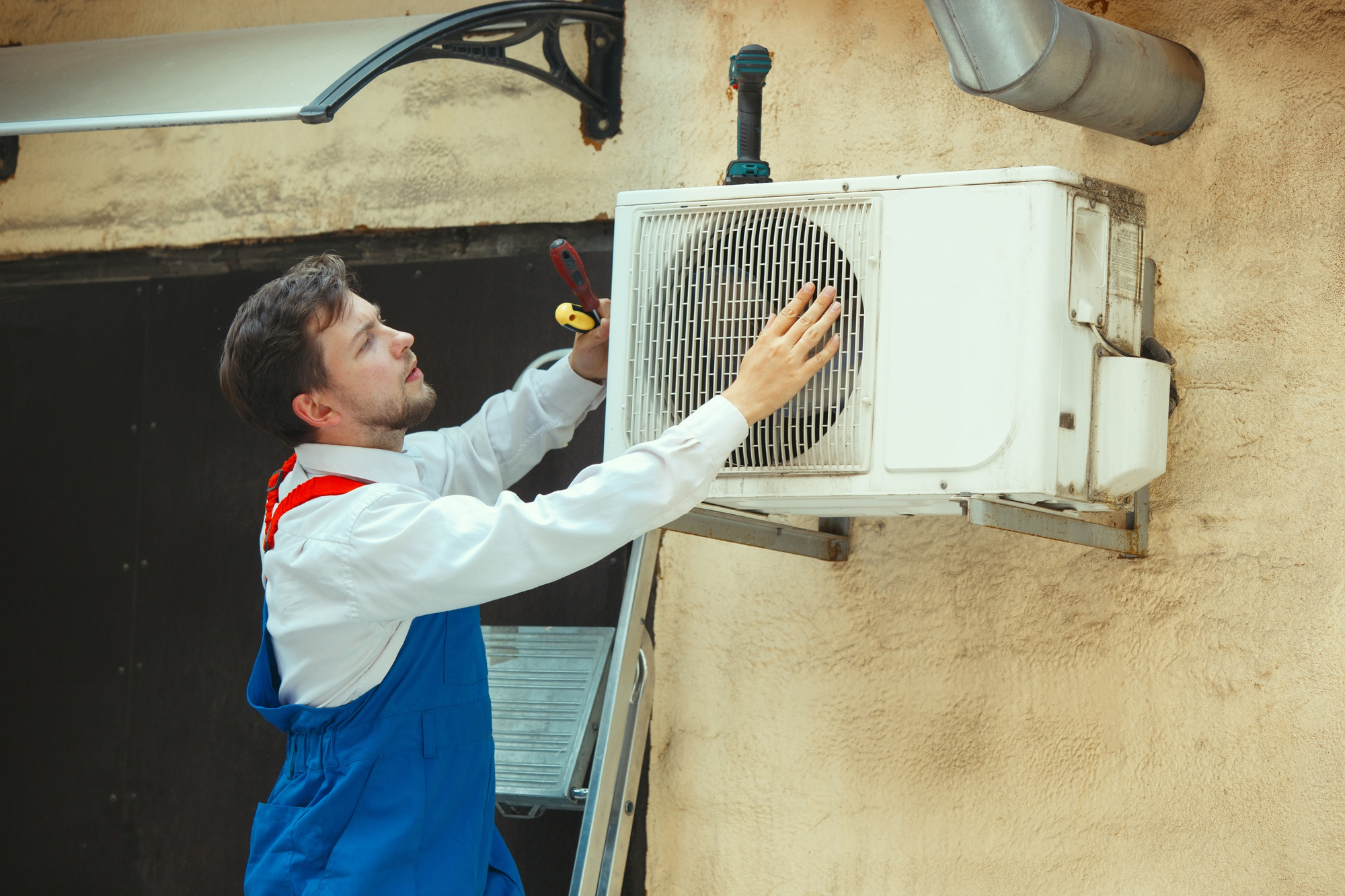 Man evaluating outdoor AC unit