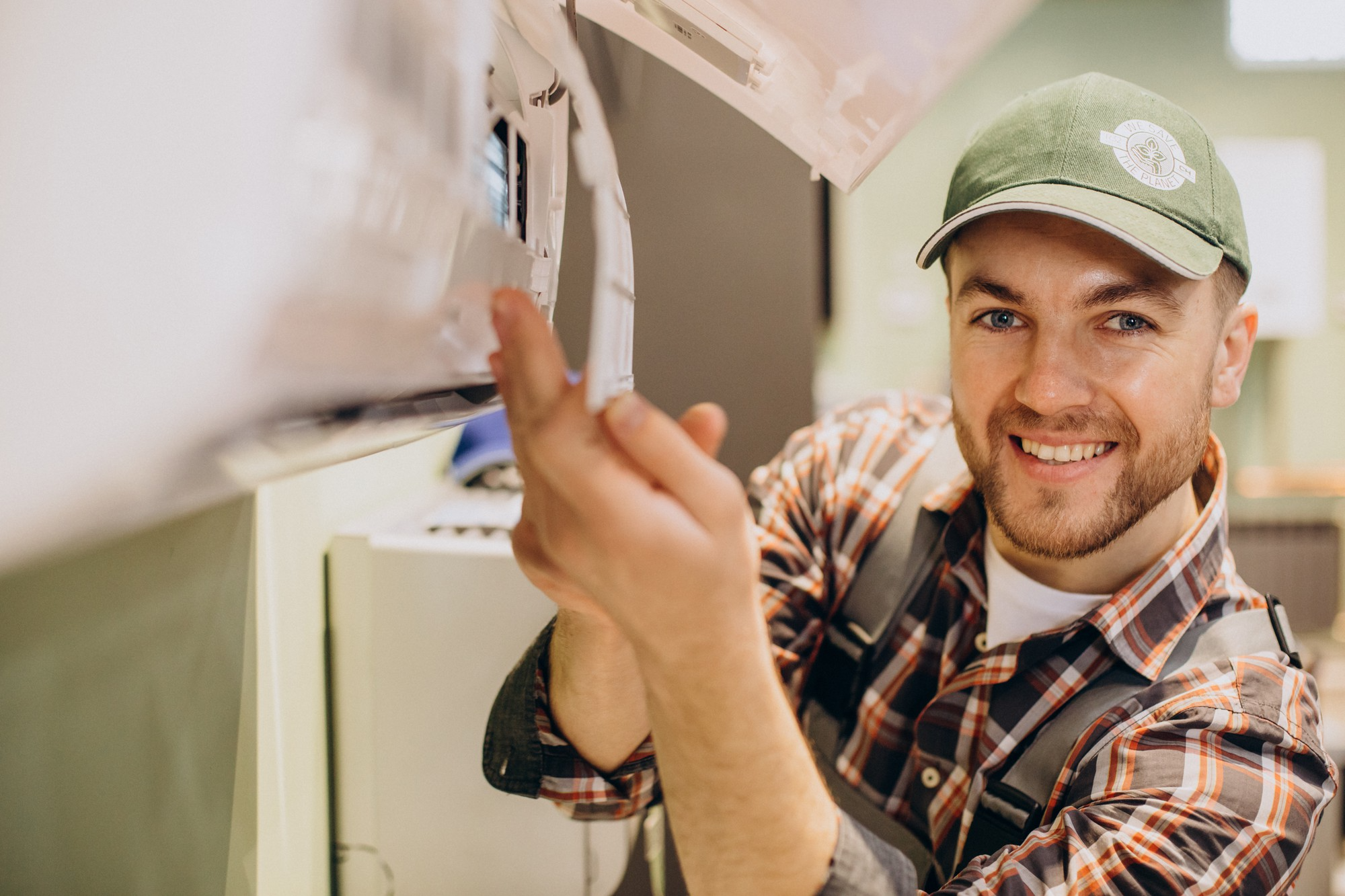 smiling man removing aircon filter
