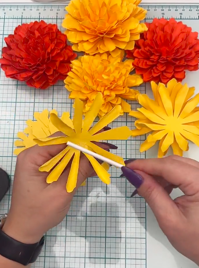 how to assemble the paper marigolds using a dowel and free paper flower svg template