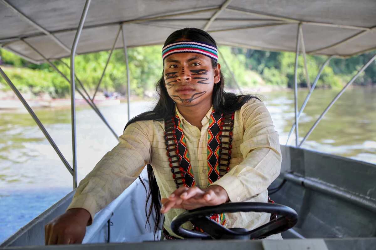 Ecuador rainforest inhabitant driving an electric boat