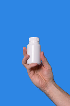 A Pilot pill container held up in the air