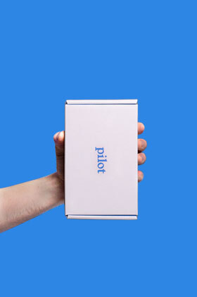 A Pilot treatment box held sideways with one hand