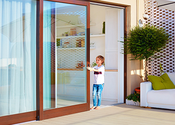 Home exterior with a sliding door and small child - Sliding Door Repairs