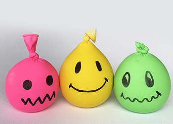 Balloons filled with sand with smiley faces drawn