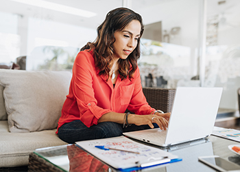 Lady working on a laptop at home