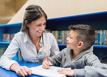 Parent sitting with child in a library