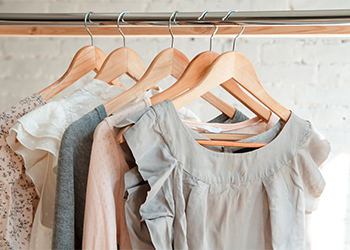Women's clothes on clothes hangers in a wardrobe