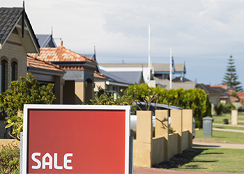 A for sale sign in front of a home