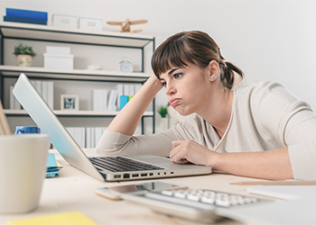 Bored woman looking at computer