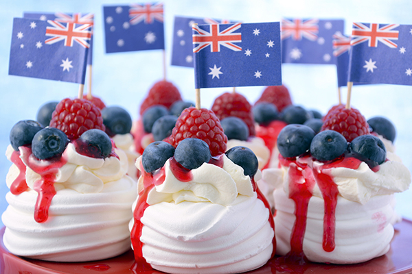 mini pavlovas with berries in front of Australian flags