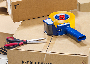 Packing boxes with scissors and packing tape