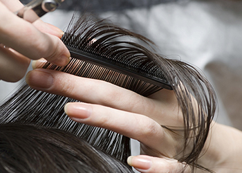 Hairdresser trimming hair