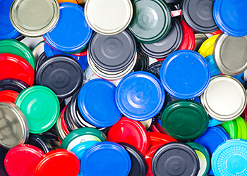 Pile of colourful metal container lids